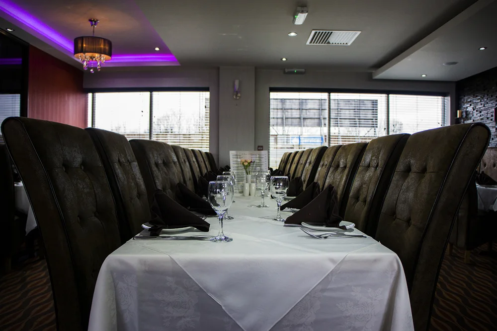A long table dressed for a group at Bombay 8