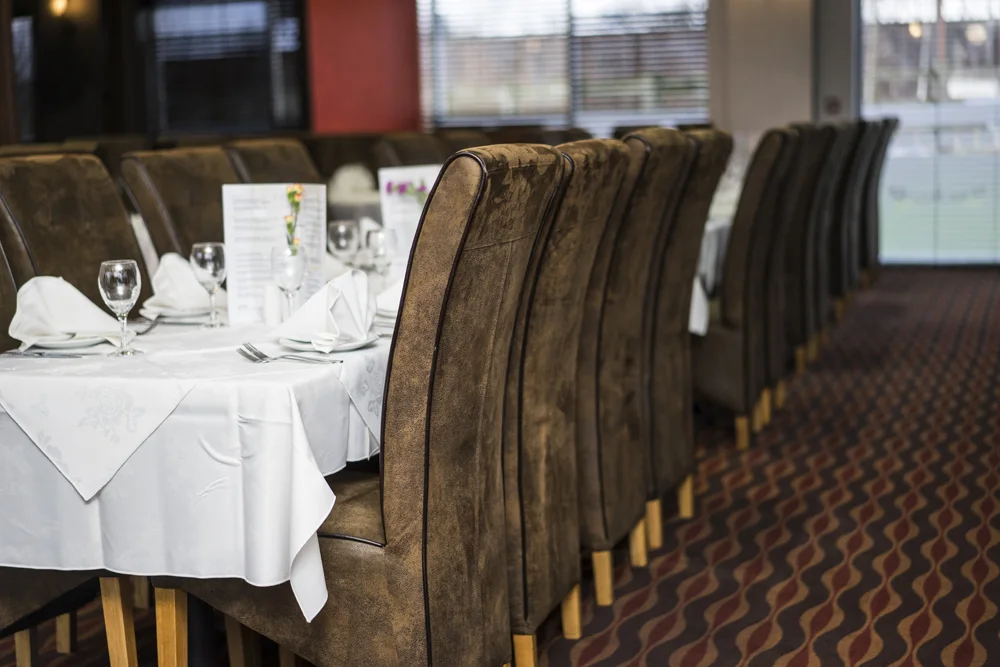 Dining tables set with white linen